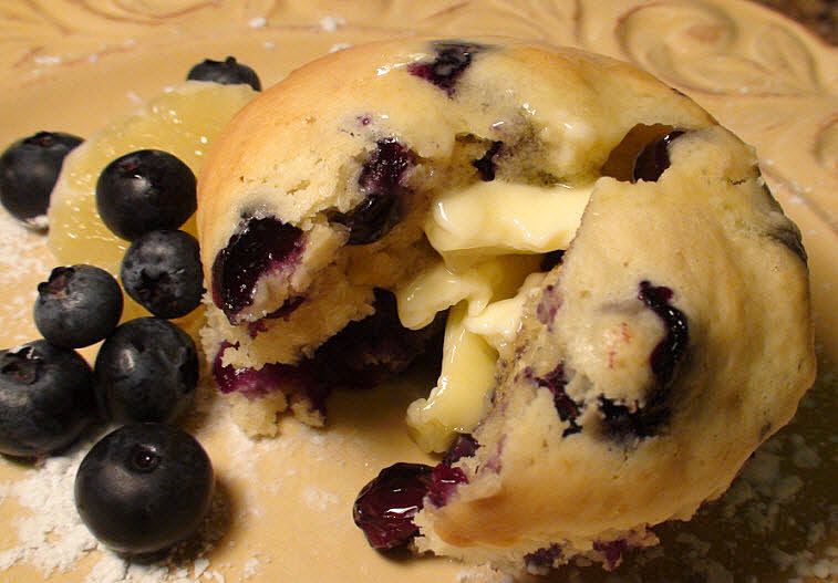 melted butter on blueberry muffins
