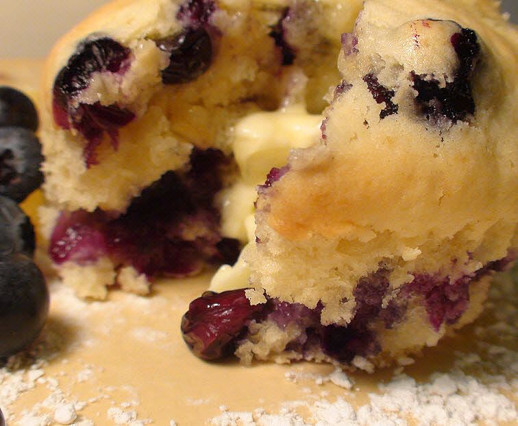 melted butter on blueberry muffins